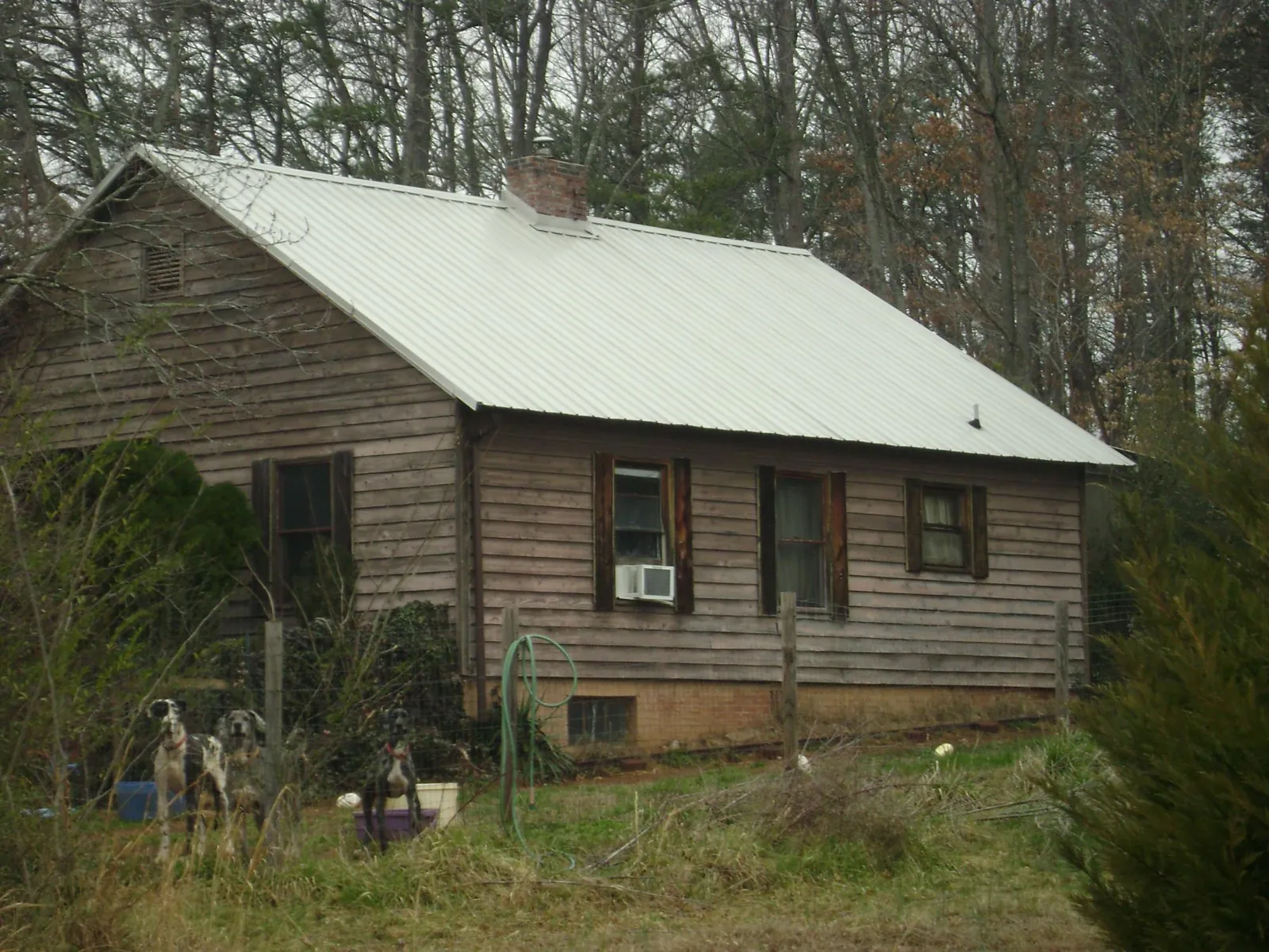 White metal roof on an old wood sided farmhouse, from a Metal Roof Installation job in Roopville